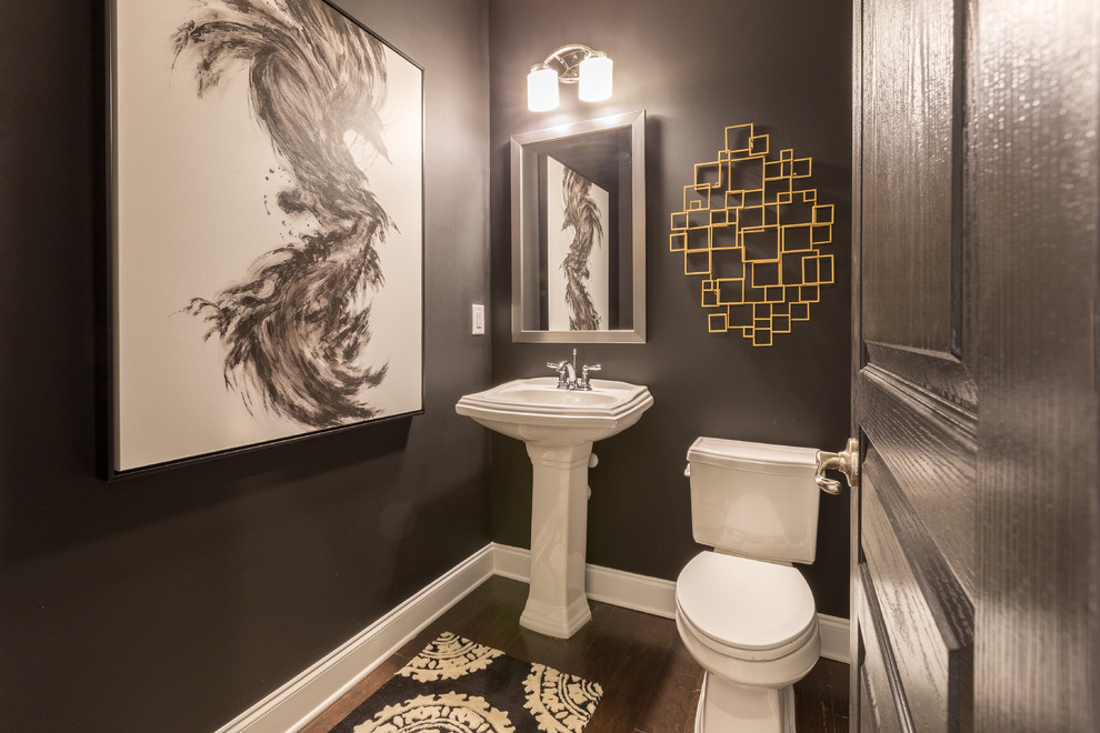 This is an example of a small contemporary cloakroom in Atlanta with a one-piece toilet, grey walls, medium hardwood flooring and a pedestal sink.