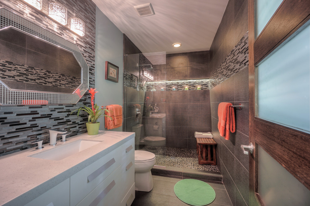 Inspiration for a small contemporary gray tile and ceramic tile ceramic tile bathroom remodel in Atlanta with furniture-like cabinets, white cabinets, a one-piece toilet, gray walls, an undermount sink and quartzite countertops