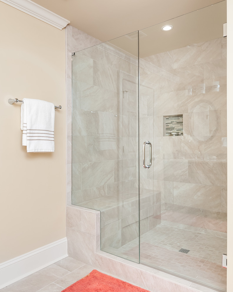 Alcove shower - mid-sized transitional master beige tile and porcelain tile porcelain tile and beige floor alcove shower idea in Atlanta with beige walls and a hinged shower door
