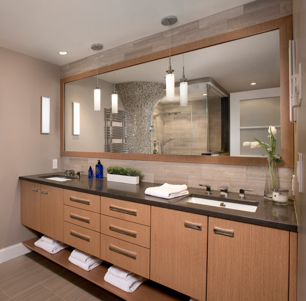 Example of a mid-sized trendy multicolored tile and stone tile marble floor, gray floor and double-sink double shower design in Boston with flat-panel cabinets, light wood cabinets, a two-piece toilet, gray walls, an undermount sink, quartz countertops, a hinged shower door, brown countertops, a niche and a floating vanity