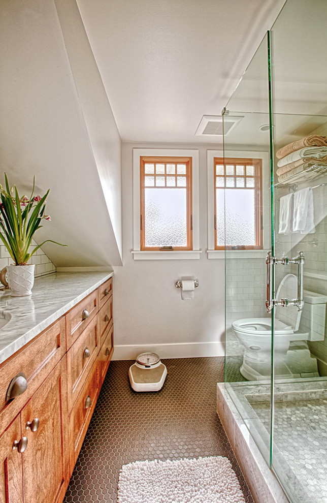 Cette image montre une salle de bain principale rustique en bois clair de taille moyenne avec un placard à porte shaker, une douche d'angle, un carrelage blanc, un carrelage métro, un mur blanc, un sol en carrelage de terre cuite, un lavabo encastré et un plan de toilette en quartz modifié.