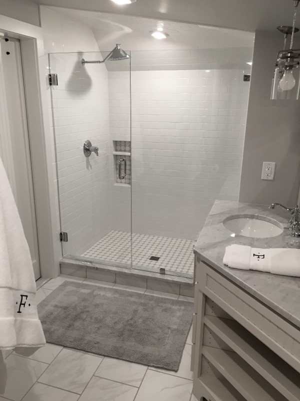 This is an example of a medium sized traditional shower room bathroom in Louisville with shaker cabinets, white cabinets, an alcove shower, white tiles, metro tiles, grey walls, marble flooring, a submerged sink and marble worktops.