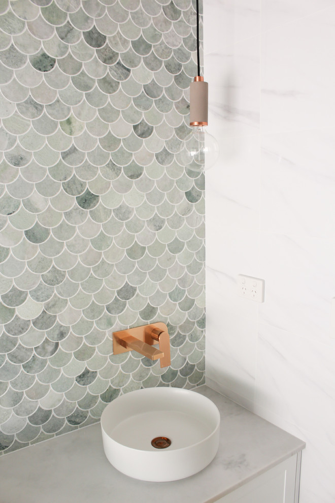 Photo of a medium sized contemporary family bathroom in Perth with flat-panel cabinets, white cabinets, a freestanding bath, a corner shower, white tiles, porcelain tiles, white walls, porcelain flooring, a vessel sink, marble worktops, grey floors, a hinged door and grey worktops.