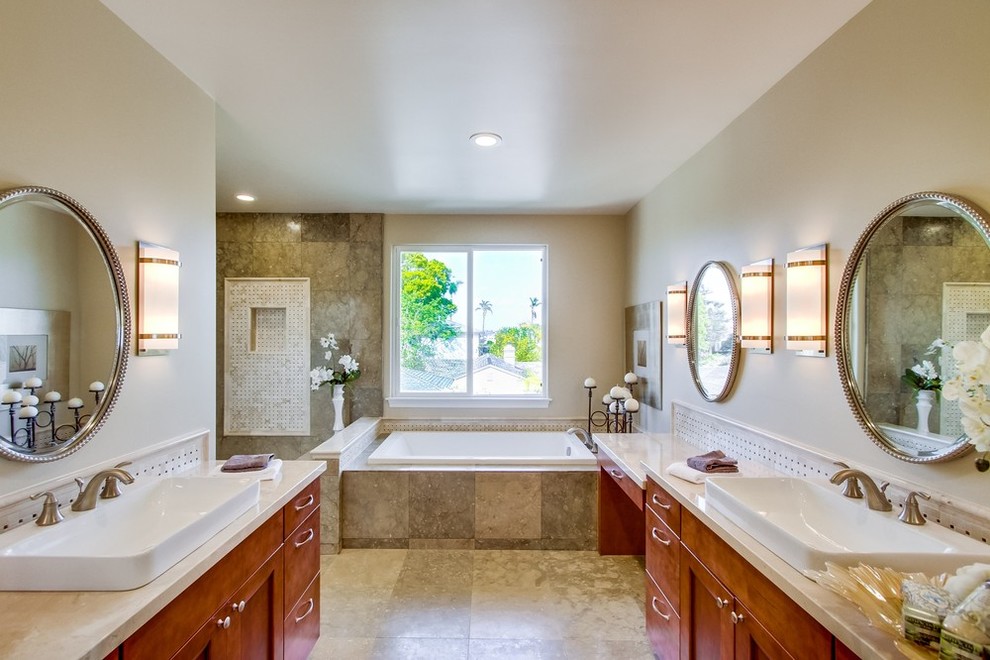 Bathroom - large transitional master beige tile and mosaic tile travertine floor bathroom idea in San Diego with a vessel sink, shaker cabinets, medium tone wood cabinets, quartz countertops and beige walls
