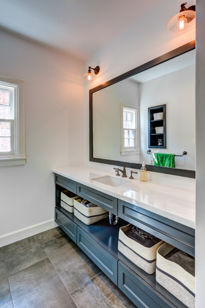 Large farmhouse kids' gray tile and subway tile porcelain tile, brown floor and single-sink bathroom photo in Houston with shaker cabinets, gray cabinets, a one-piece toilet, white walls, an undermount sink, quartz countertops, a hinged shower door, gray countertops and a built-in vanity