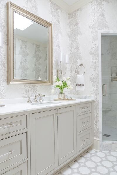 Corner shower - large transitional master porcelain tile and gray floor corner shower idea in New Orleans with beaded inset cabinets, white cabinets, multicolored walls, an undermount sink, marble countertops and a hinged shower door