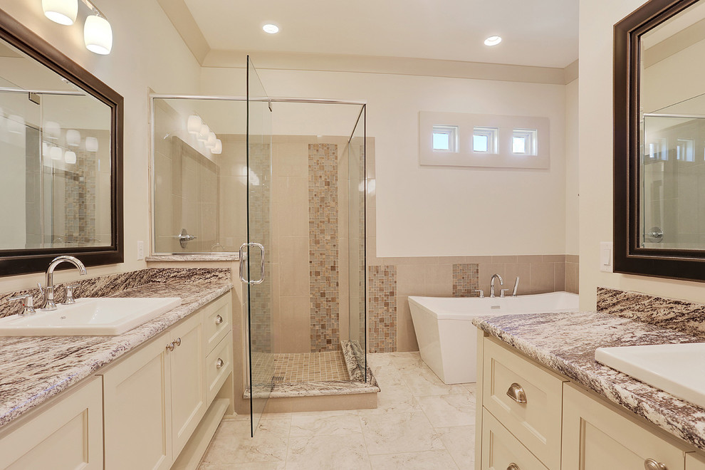 Bathroom - large traditional master beige tile, brown tile, multicolored tile and mosaic tile ceramic tile bathroom idea in New Orleans with recessed-panel cabinets, beige cabinets, a one-piece toilet, white walls, a drop-in sink and granite countertops