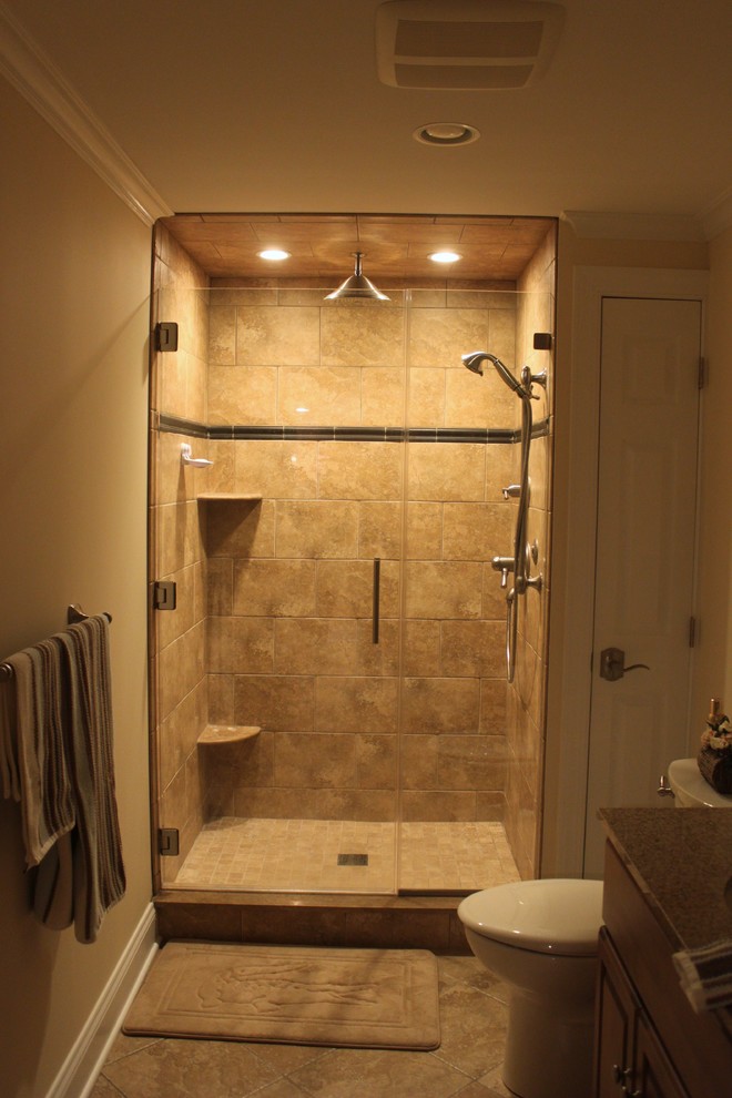 This is an example of a medium sized traditional shower room bathroom in Philadelphia with raised-panel cabinets, dark wood cabinets, an alcove shower, a two-piece toilet, ceramic tiles, beige walls, ceramic flooring, a submerged sink, granite worktops, beige floors, a hinged door and beige tiles.