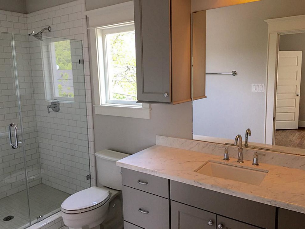 Mid-sized trendy 3/4 white tile and subway tile bathroom photo in Houston with shaker cabinets, gray cabinets, a two-piece toilet, beige walls, an undermount sink and marble countertops
