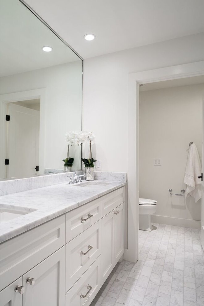 Transitional kids' gray tile and stone tile marble floor bathroom photo in Austin with shaker cabinets, white cabinets, a two-piece toilet, white walls, an undermount sink and marble countertops