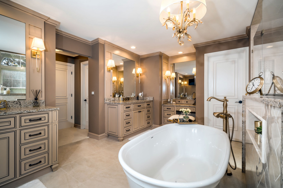 Elegant master beige floor and double-sink freestanding bathtub photo in Detroit with recessed-panel cabinets, beige cabinets, brown walls, gray countertops and a built-in vanity