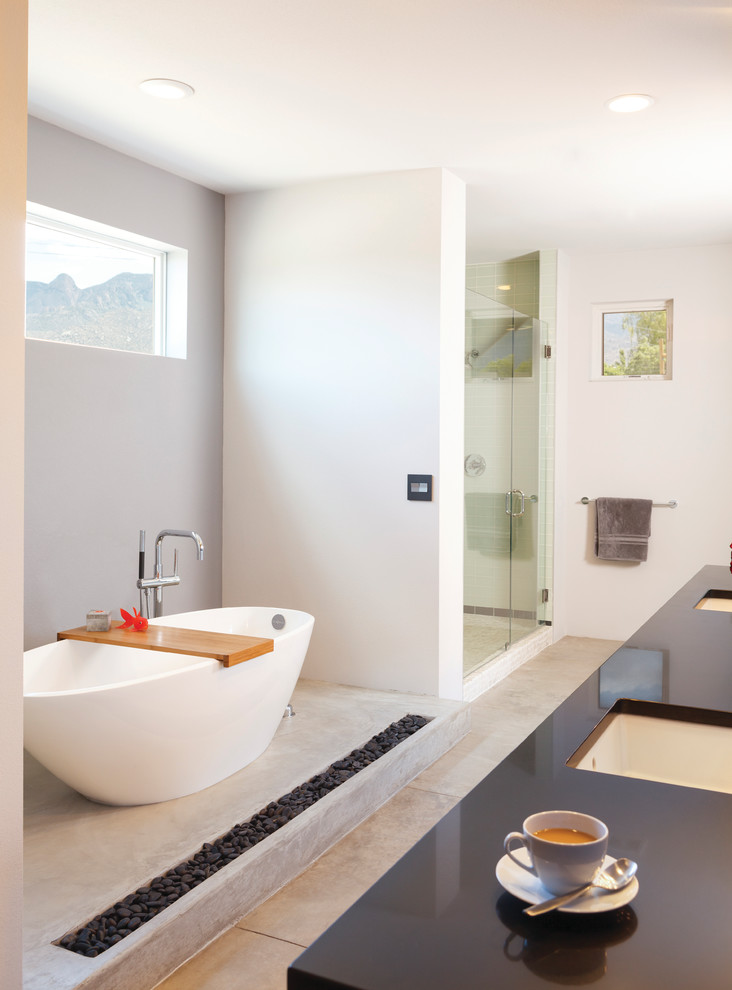 Diseño de cuarto de baño contemporáneo con lavabo bajoencimera, bañera exenta, ducha empotrada y paredes blancas