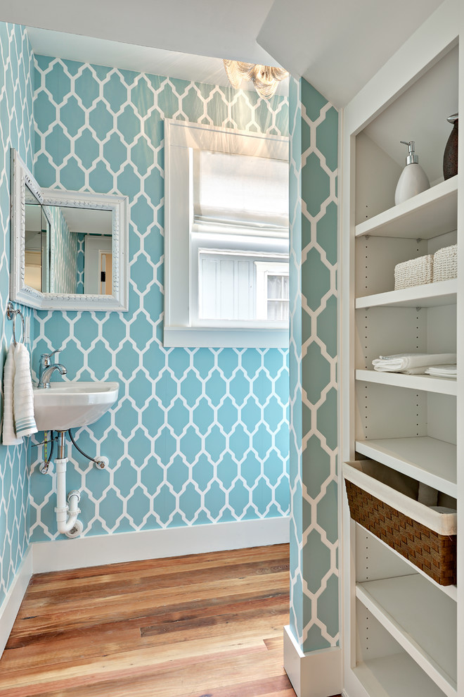 Example of a small transitional medium tone wood floor bathroom design in Austin with a wall-mount sink, blue walls and open cabinets