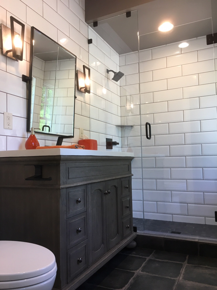 Inspiration for a small eclectic family bathroom in St Louis with beaded cabinets, distressed cabinets, a walk-in shower, a two-piece toilet, white tiles, metro tiles, grey walls, porcelain flooring, an integrated sink, concrete worktops, black floors, a hinged door and white worktops.