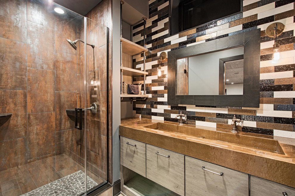 This is an example of a medium sized traditional shower room bathroom in Cleveland with flat-panel cabinets, multi-coloured walls, an alcove shower, brown tiles, multi-coloured tiles, a trough sink, light wood cabinets, metal tiles, light hardwood flooring, zinc worktops, brown floors, a hinged door and brown worktops.