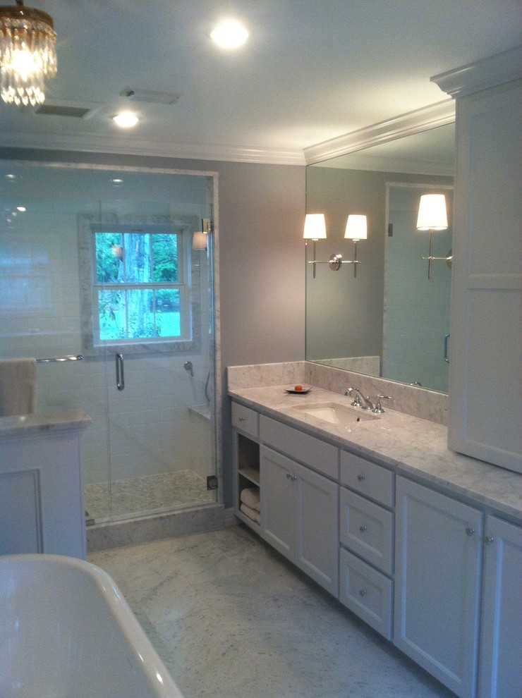 Medium sized classic ensuite bathroom in Houston with a submerged sink, shaker cabinets, white cabinets, marble worktops, a freestanding bath, a walk-in shower, a two-piece toilet, white tiles, stone tiles, grey walls and marble flooring.