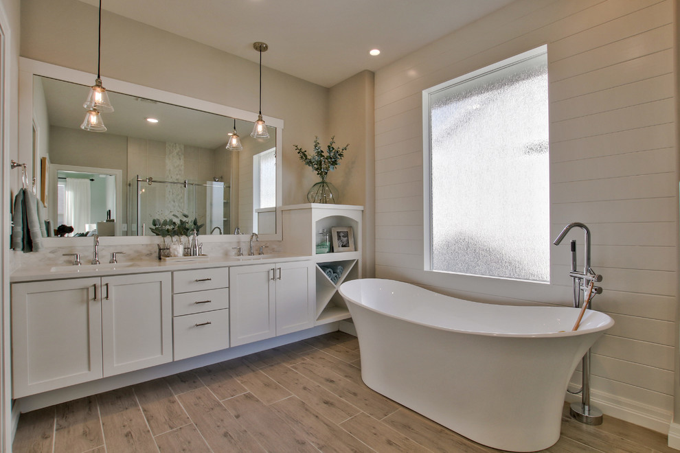 Example of a large cottage master marble tile and white tile porcelain tile and gray floor bathroom design in Wichita with recessed-panel cabinets, white cabinets, quartz countertops, a two-piece toilet, gray walls and an undermount sink