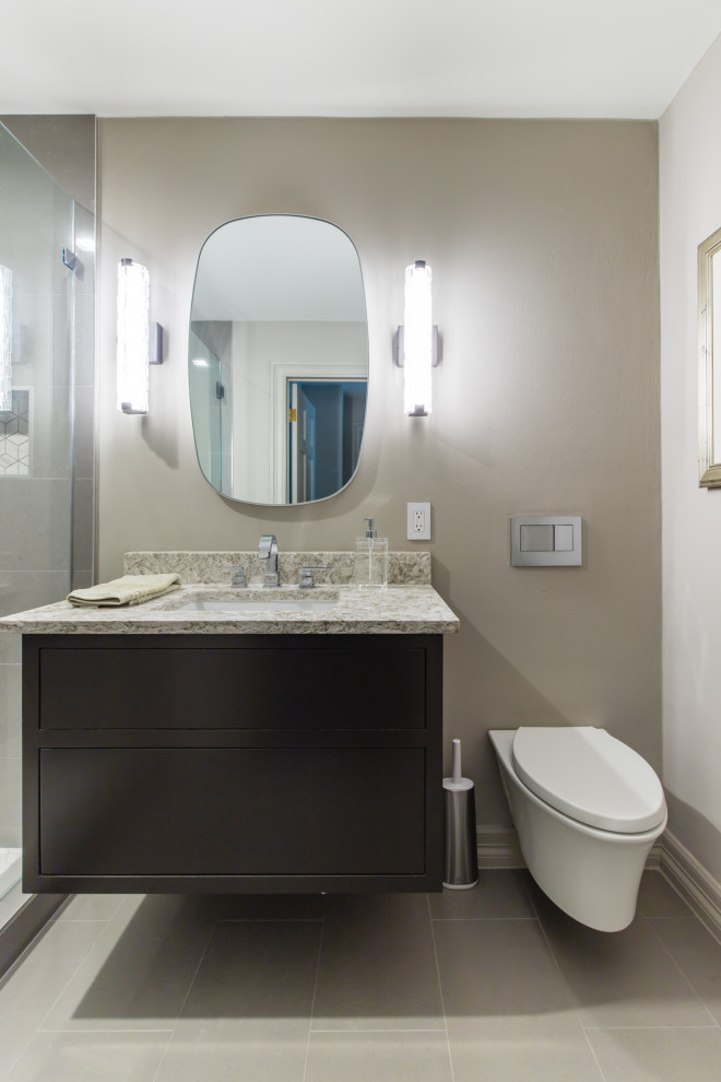 Medium sized modern bathroom in Dallas with flat-panel cabinets, black cabinets, an alcove shower, grey tiles, porcelain tiles, beige walls, porcelain flooring, a submerged sink, granite worktops, grey floors, a hinged door and beige worktops.
