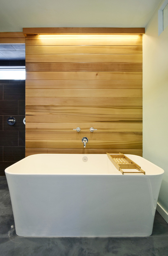This is an example of a large contemporary ensuite bathroom in Austin with a submerged sink, flat-panel cabinets, grey cabinets, a freestanding bath, a walk-in shower, a two-piece toilet, brown tiles, ceramic tiles, green walls, concrete flooring and concrete worktops.