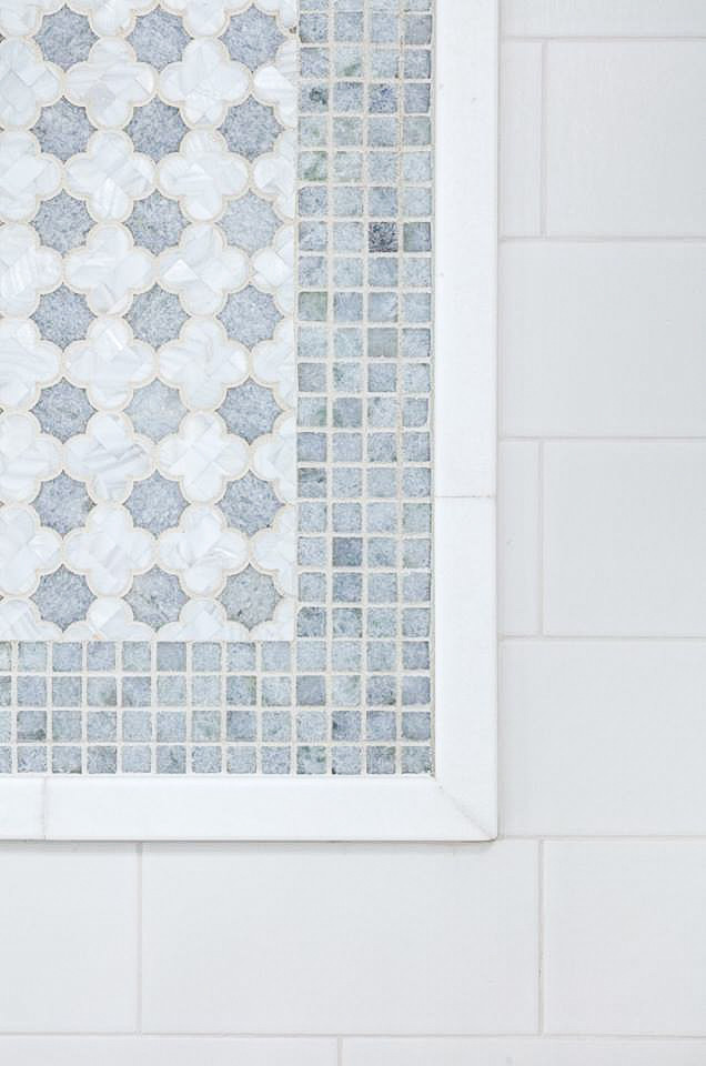 Small transitional 3/4 blue tile and stone tile mosaic tile floor bathroom photo in New York with blue walls