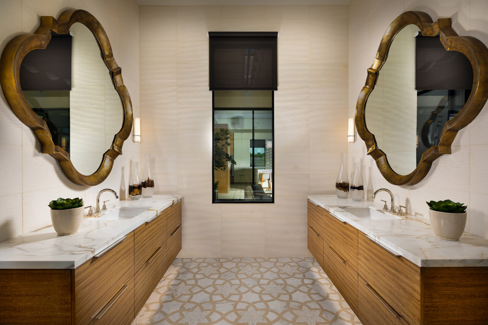 Photo of a large contemporary ensuite bathroom in Phoenix with flat-panel cabinets, medium wood cabinets, porcelain flooring, a submerged sink, engineered stone worktops, white worktops, beige tiles, beige walls and multi-coloured floors.