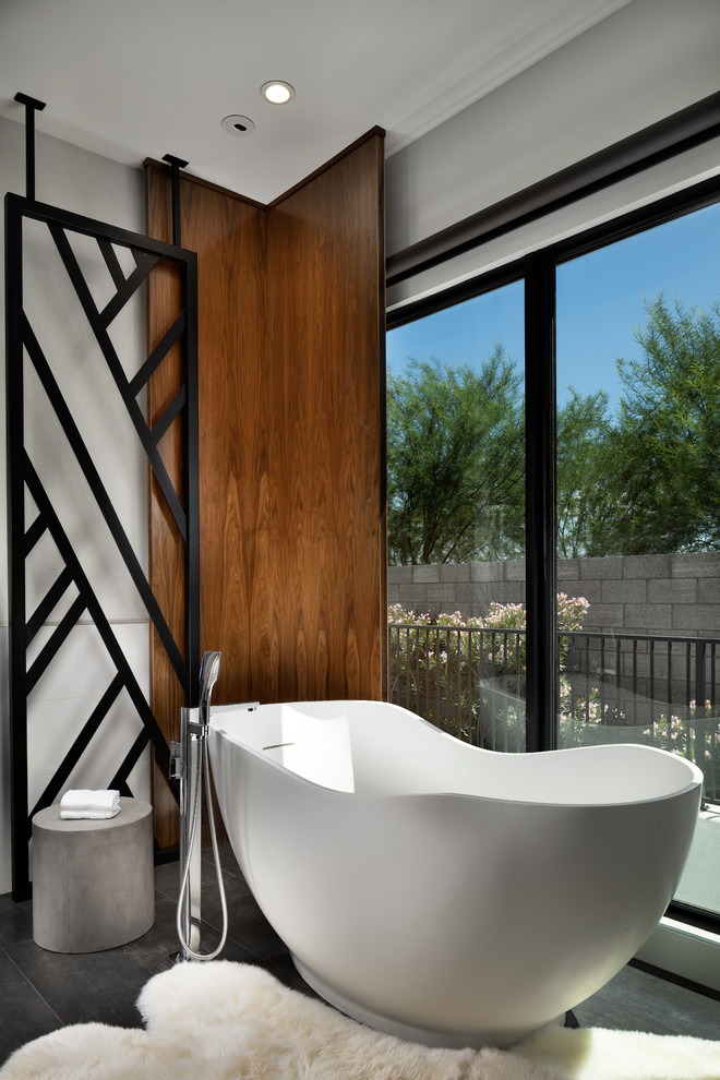 Design ideas for a large modern ensuite bathroom in Phoenix with a freestanding bath, dark hardwood flooring and brown floors.