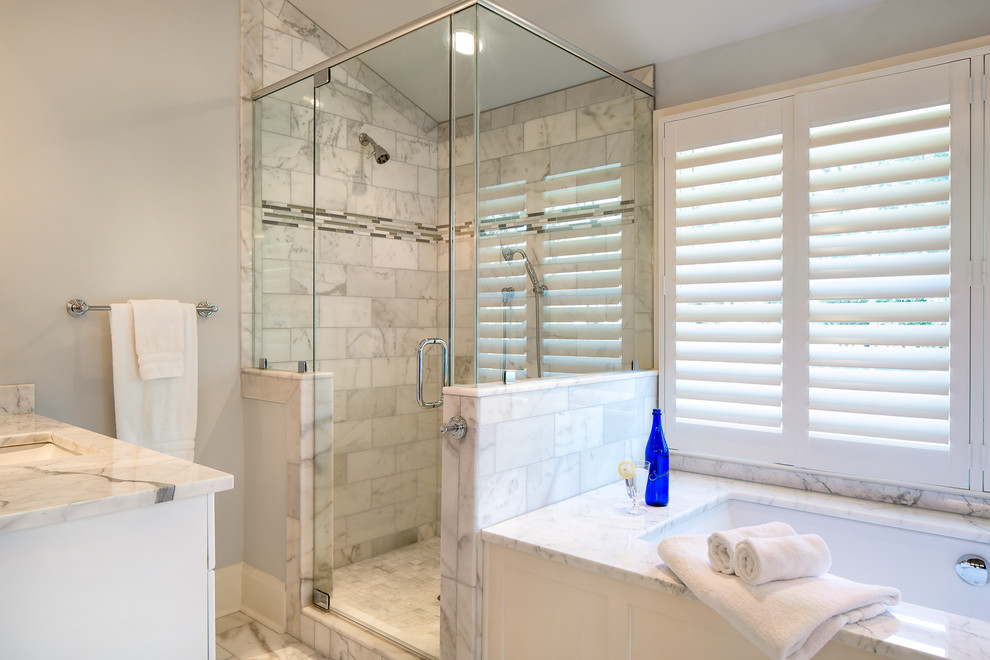 Corner shower - mid-sized traditional master white tile and stone tile marble floor corner shower idea in Other with an undermount sink, recessed-panel cabinets, white cabinets, marble countertops, an undermount tub, a one-piece toilet and white walls
