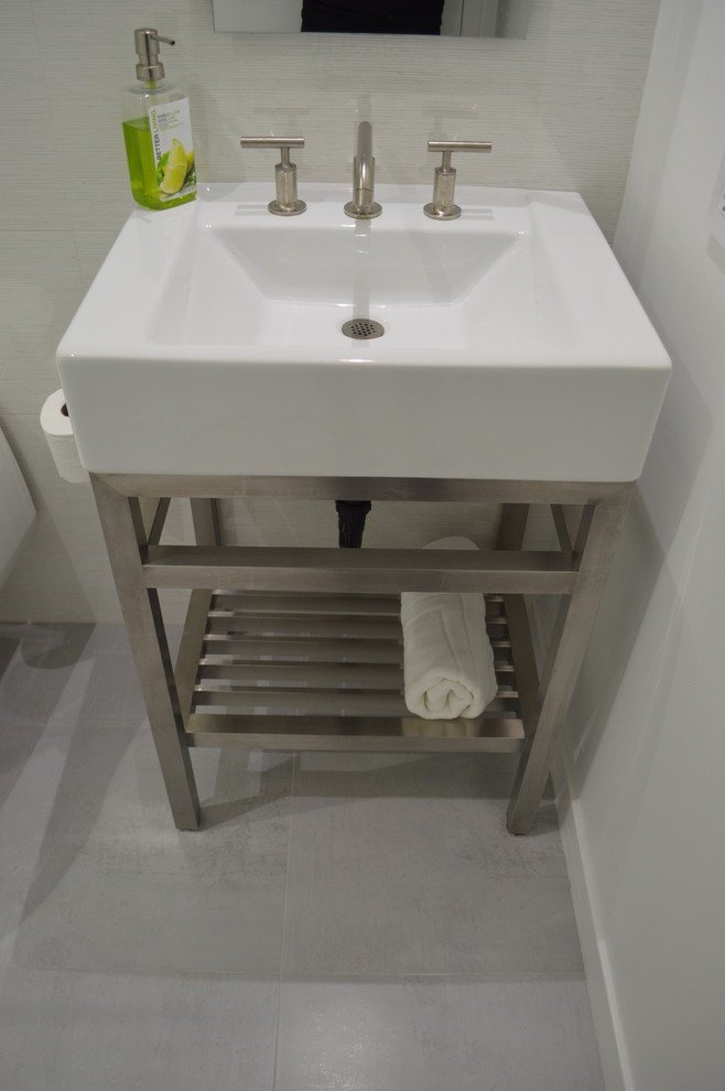 This is an example of a small contemporary ensuite bathroom in San Diego with a pedestal sink, a built-in bath, a two-piece toilet, white tiles, porcelain tiles, white walls and porcelain flooring.