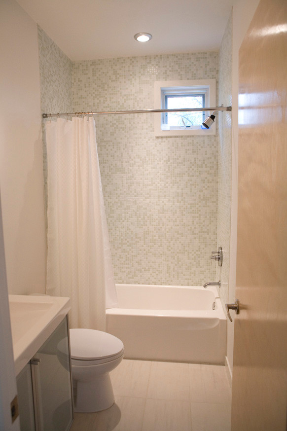 Example of a minimalist white tile and glass tile ceramic tile bathroom design in Minneapolis with a vessel sink, glass-front cabinets, a one-piece toilet and white walls