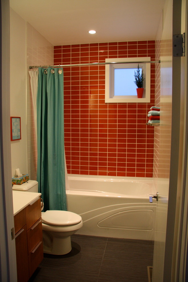 Cette photo montre une salle de bain tendance en bois clair avec une vasque, un placard à porte plane, une baignoire posée, un combiné douche/baignoire, WC à poser, un carrelage rouge, un carrelage en pâte de verre, un mur blanc et un sol en carrelage de céramique.