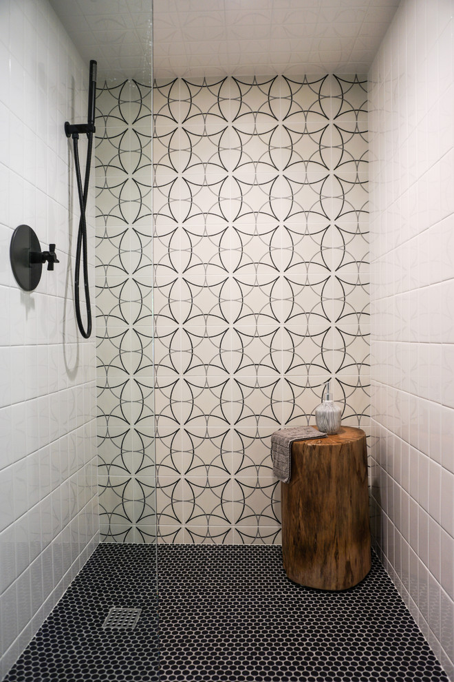 Пример оригинального дизайна: ванная комната в скандинавском стиле с душем в нише, черно-белой плиткой, цементной плиткой, черным полом и душем с распашными дверями