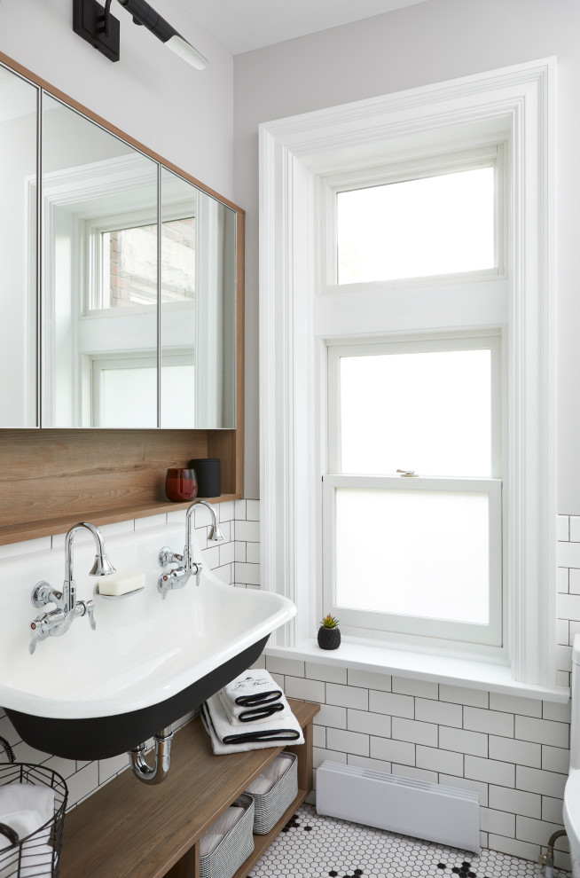 Photo of a small retro family bathroom in Toronto with open cabinets, a freestanding bath, a one-piece toilet, white tiles, ceramic tiles, white walls, white floors and a shower curtain.