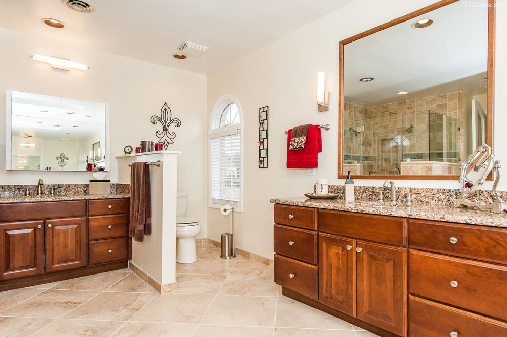 Inspiration for a medium sized traditional ensuite bathroom in DC Metro with raised-panel cabinets, medium wood cabinets, a built-in bath, a corner shower, a two-piece toilet, beige tiles, travertine tiles, beige walls, travertine flooring, a submerged sink, granite worktops, beige floors and a hinged door.