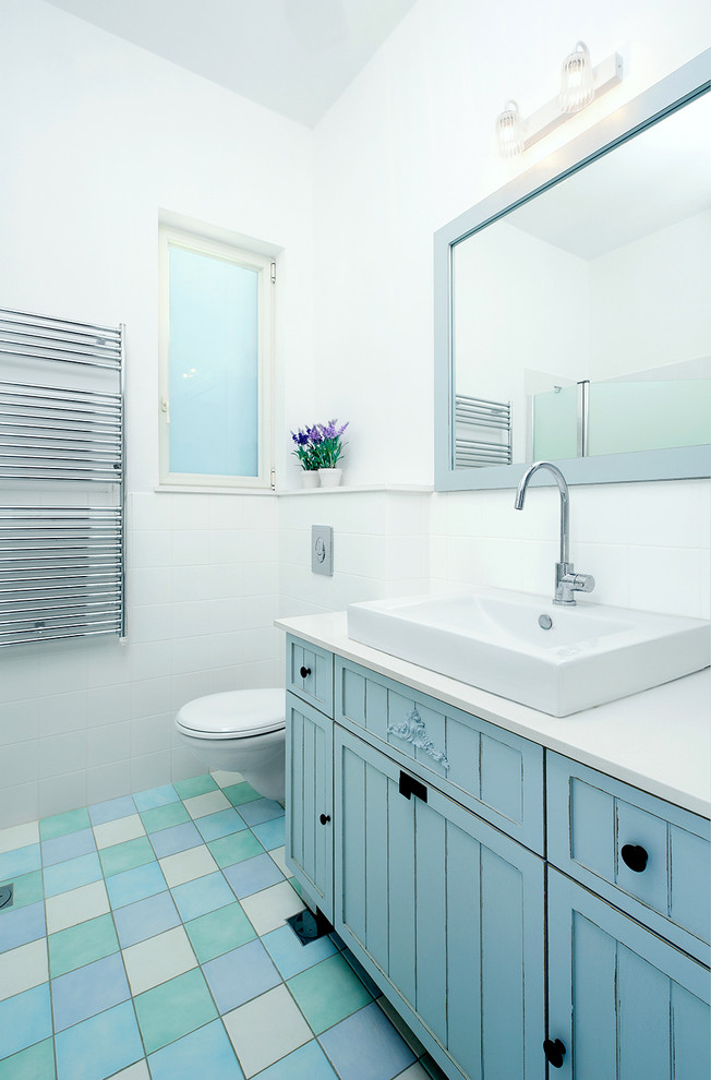 Example of a minimalist blue tile blue floor bathroom design in Tel Aviv with a vessel sink and blue cabinets