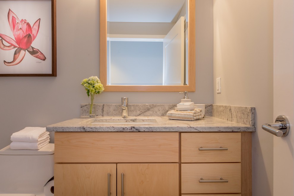 Mid-sized trendy 3/4 white tile and ceramic tile ceramic tile bathroom photo in Portland Maine with flat-panel cabinets, medium tone wood cabinets, a two-piece toilet, gray walls, an undermount sink and granite countertops