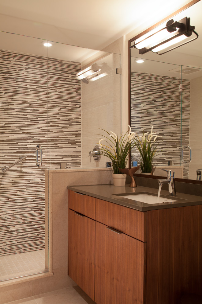 Exempel på ett klassiskt grå grått badrum, med ett undermonterad handfat, släta luckor, skåp i mörkt trä, en dusch i en alkov, flerfärgad kakel och beige väggar