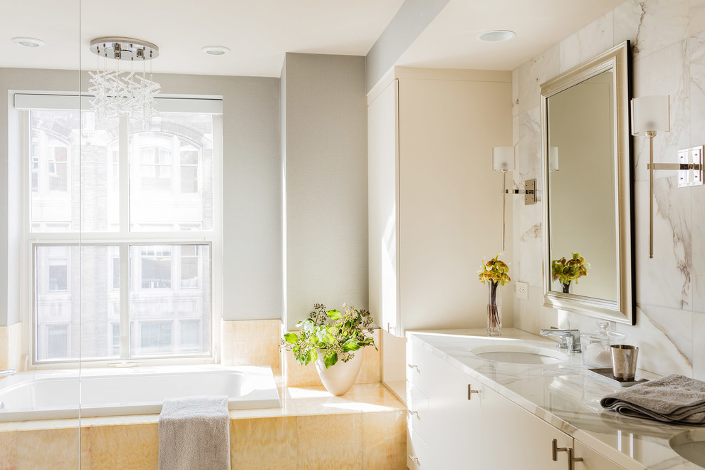 Design ideas for a classic ensuite bathroom in Boston with flat-panel cabinets, beige cabinets, a built-in bath, grey walls and a submerged sink.