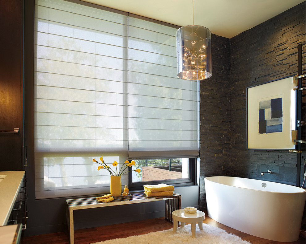 Mid-sized mountain style master brown tile and stone tile corner bathtub photo in New York with brown walls
