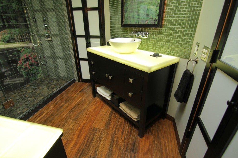 Idee per una stanza da bagno padronale etnica con ante nere e top in superficie solida