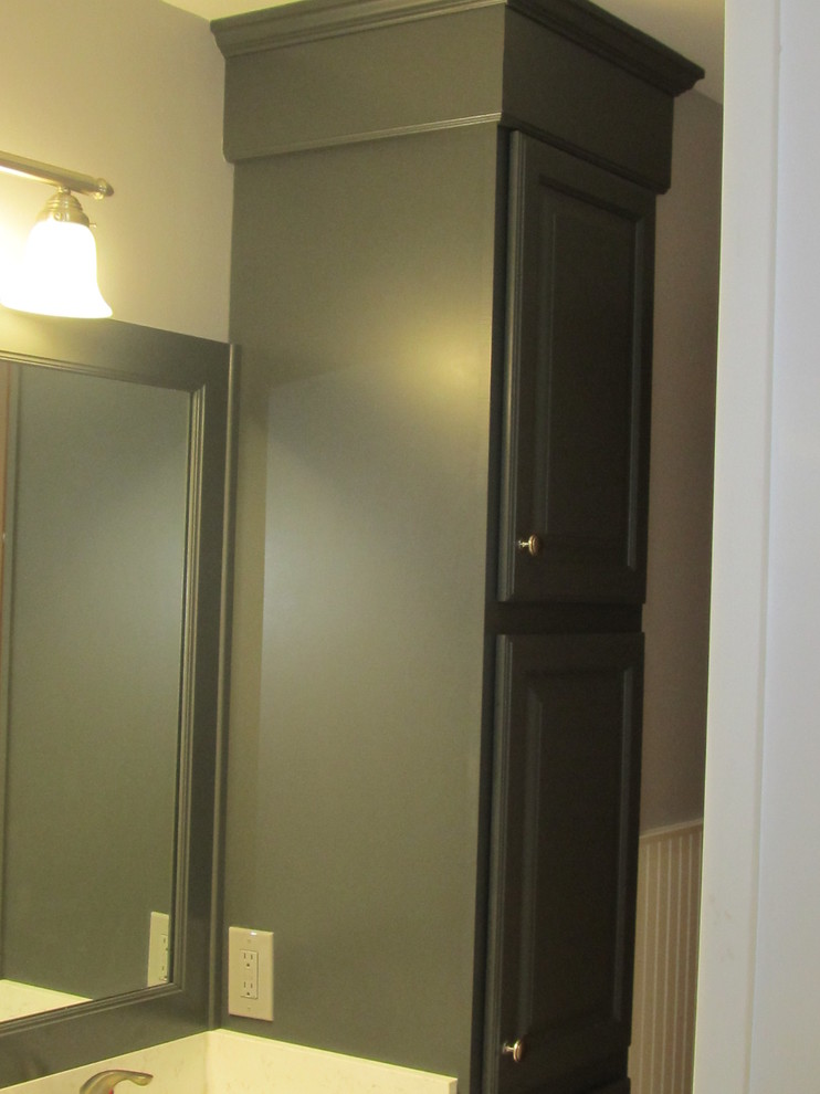 Esempio di una stanza da bagno tradizionale con lavabo sottopiano, ante con bugna sagomata, ante grigie, top in quarzo composito, pareti grigie e pavimento in gres porcellanato