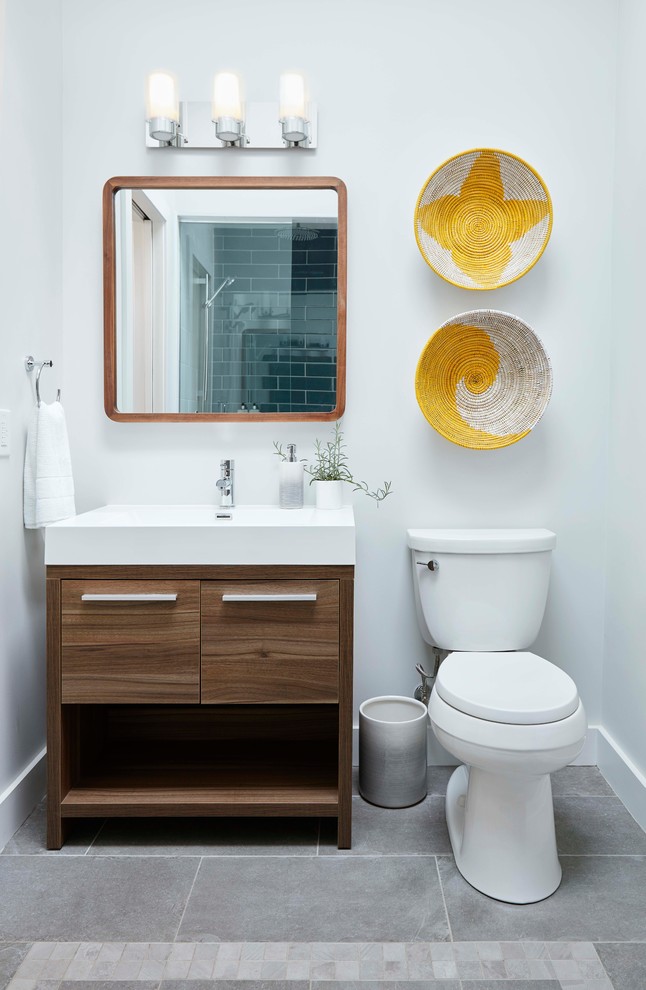 Medium sized traditional grey and brown shower room bathroom in Toronto with flat-panel cabinets, brown cabinets, an alcove shower, a two-piece toilet, blue tiles, ceramic tiles, grey walls, ceramic flooring, grey floors, a hinged door and a console sink.
