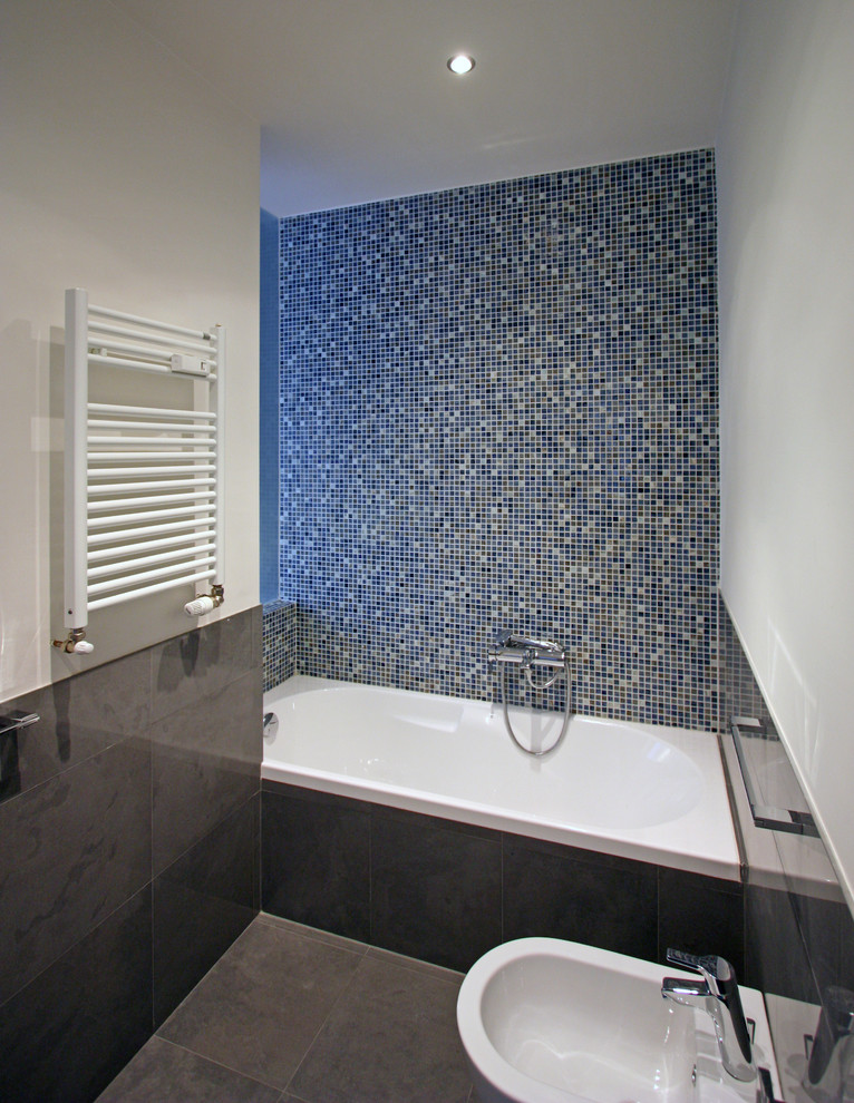 Drop-in bathtub - mid-sized contemporary master blue tile and mosaic tile ceramic tile drop-in bathtub idea in Rome with a drop-in sink, open cabinets, a wall-mount toilet and blue walls