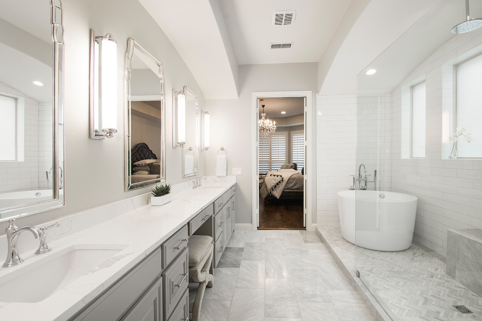 This is an example of a medium sized traditional ensuite bathroom in Dallas with raised-panel cabinets, grey cabinets, a japanese bath, a walk-in shower, a two-piece toilet, beige tiles, ceramic tiles, beige walls, marble flooring, a submerged sink, engineered stone worktops, grey floors, an open shower and white worktops.