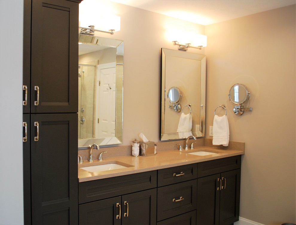 This is an example of a medium sized traditional ensuite bathroom in Columbus with recessed-panel cabinets, grey cabinets, a built-in bath, a one-piece toilet, beige tiles, porcelain tiles, grey walls, porcelain flooring, a submerged sink, engineered stone worktops, beige floors and a hinged door.