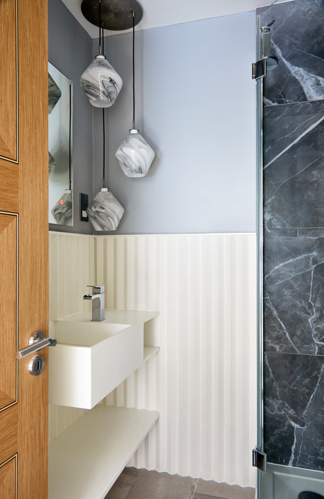 Inspiration for a small contemporary ensuite bathroom in London with flat-panel cabinets, white cabinets, a corner shower, white tiles, porcelain tiles, porcelain flooring, solid surface worktops, grey floors, a hinged door, a single sink and a floating vanity unit.
