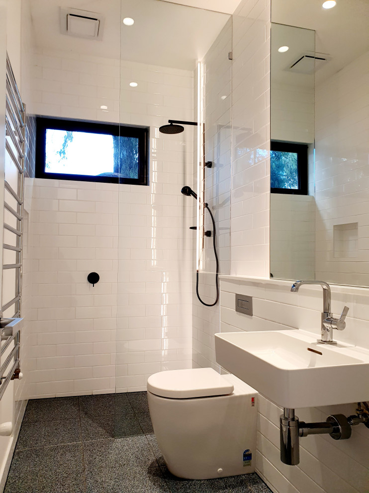 Small contemporary shower room bathroom in Melbourne with a walk-in shower, white tiles, ceramic tiles, white walls, porcelain flooring, blue floors, an open shower and a single sink.