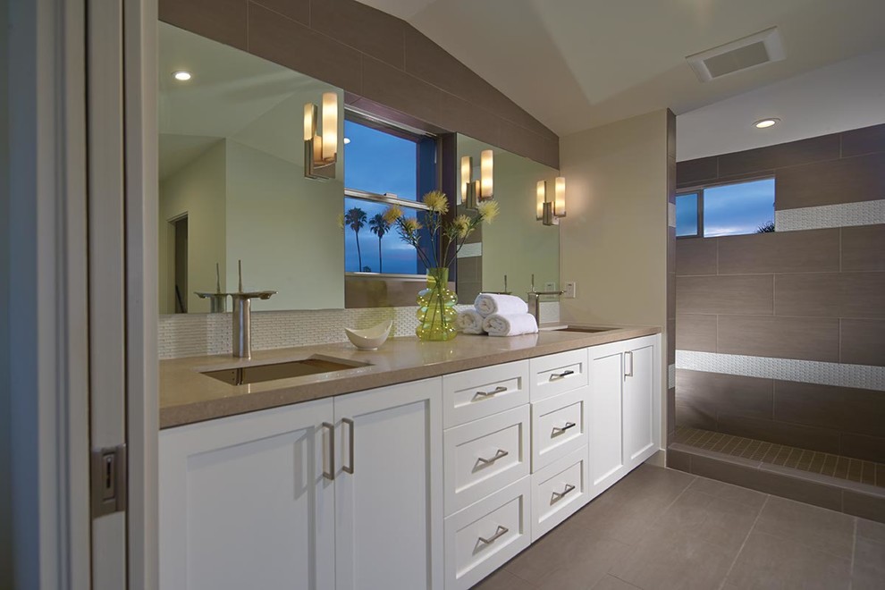 This is an example of a large contemporary ensuite bathroom in Los Angeles with shaker cabinets, white cabinets, a walk-in shower, grey tiles, porcelain tiles, beige walls, porcelain flooring, a submerged sink and engineered stone worktops.