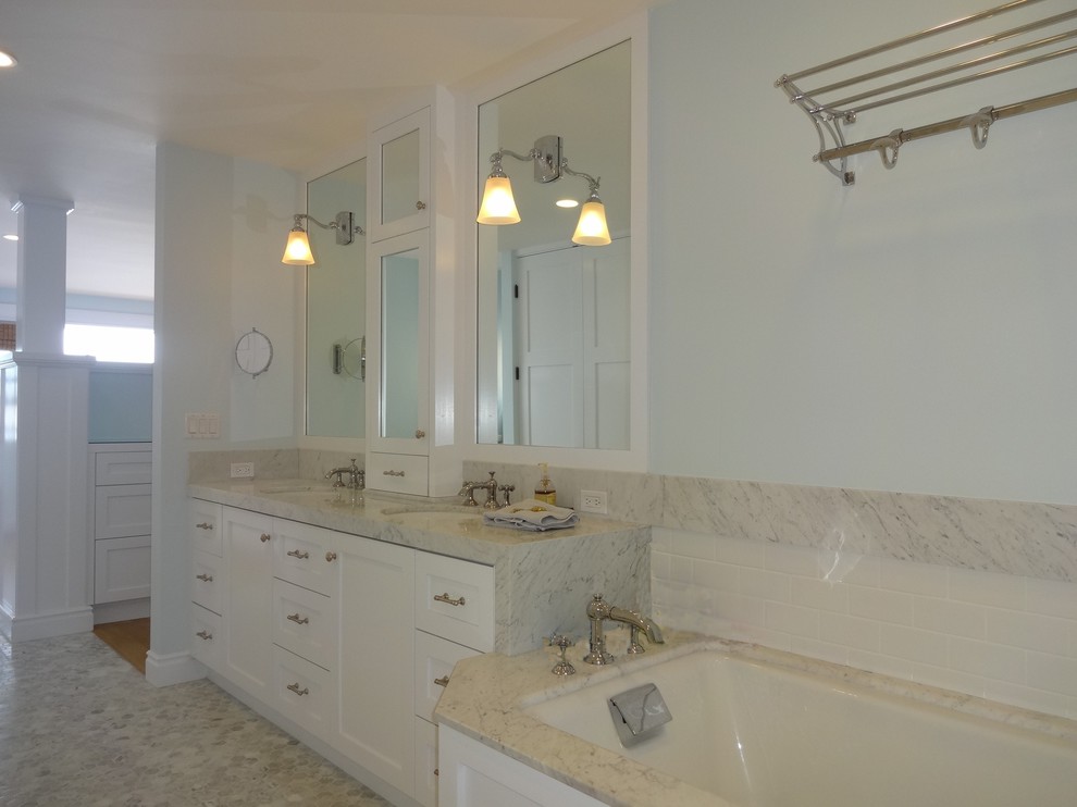 Large coastal ensuite bathroom in Orange County with shaker cabinets, white cabinets, a submerged bath, an alcove shower, a two-piece toilet, white tiles, ceramic tiles, white walls, mosaic tile flooring, a submerged sink, grey floors, a wall niche and a built in vanity unit.