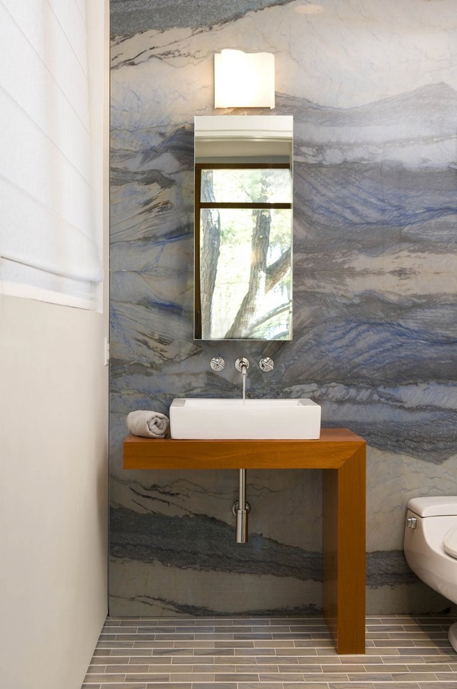 Bathroom - contemporary blue tile and stone slab bathroom idea in DC Metro with wood countertops and brown countertops
