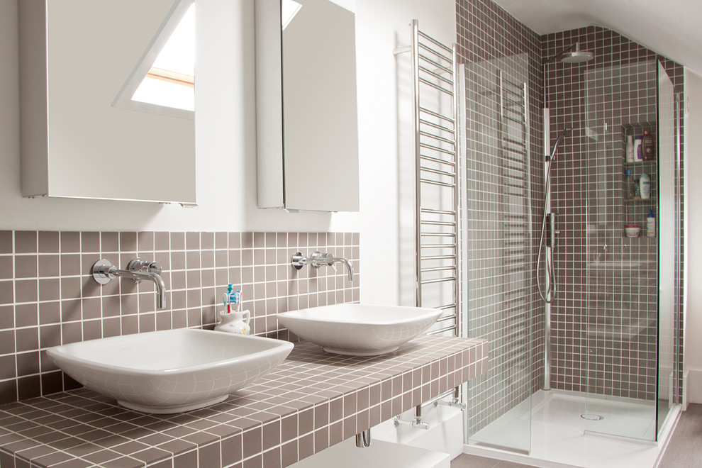 Medium sized contemporary bathroom in London with open cabinets, a corner shower, brown tiles, mosaic tiles, a vessel sink, grey floors, white walls, a hinged door and brown worktops.